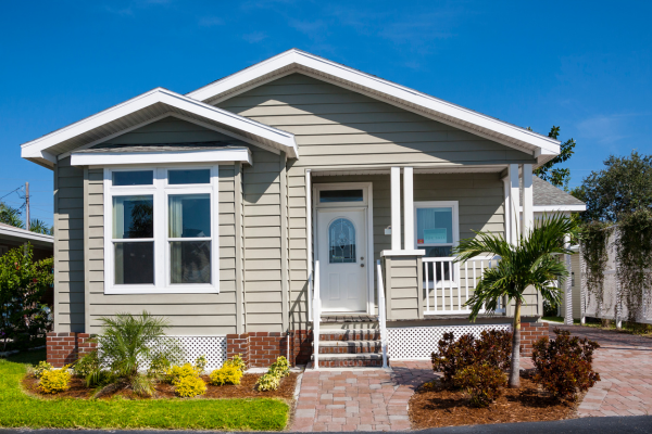 The picture of a starter home with white door and a front yard